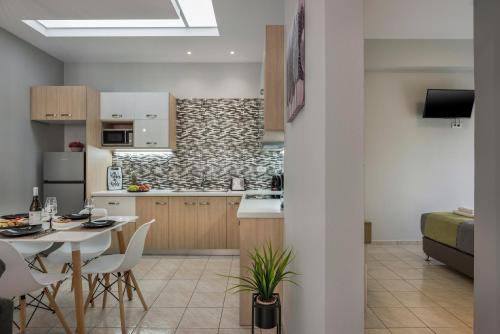 a kitchen and living room with a table and chairs at JT Apartments in Kissamos