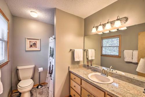 a bathroom with a toilet and a sink at Secluded Lavinder Laurel Leaf Cottage Near Creek in Lakemont