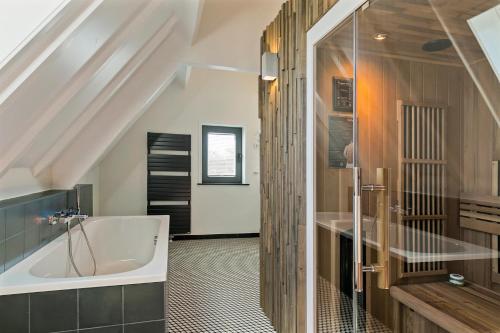a bathroom with a tub and a sink at DRL08 Luxury apartment with sauna in centre in Domburg