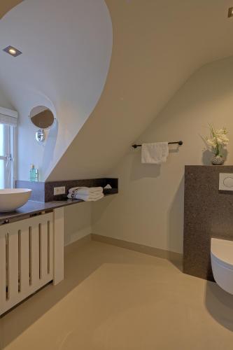 a bathroom with a sink and a toilet at Grandcafé Boutique Hotel Eemland in Eemnes