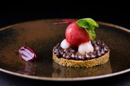 a dessert with a strawberry on top on a plate at IBB Hotel Grand Hotel Lublin in Lublin