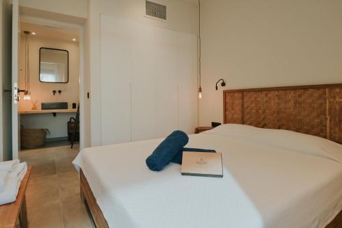 a bedroom with a bed with a book on it at Elsa Luxury Apartments in Paleros