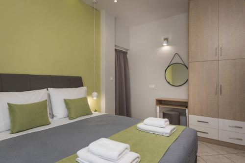 a bedroom with a bed with folded towels on it at JT Apartments in Kissamos