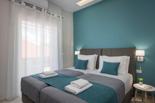 a bedroom with a large bed with towels on it at JT Apartments in Kissamos
