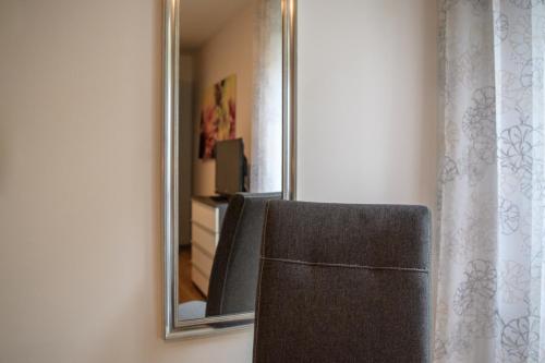 a mirror and a chair in front of a mirror at Villa Sonnenblick in Cochem
