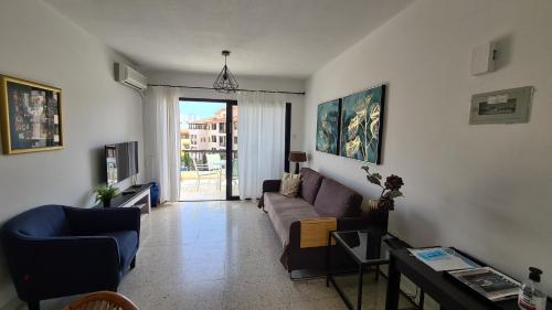 a living room with a couch and a table at Kings Avenue - Natalia's Apt in Paphos