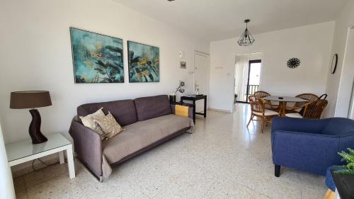 a living room with a couch and a table at Kings Avenue - Natalia's Apt in Paphos