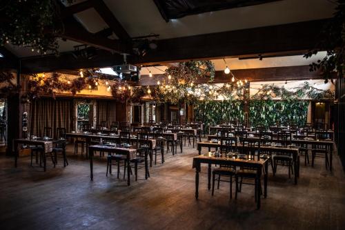 a dining room with tables and chairs and chandeliers at South Causey Inn in Stanley