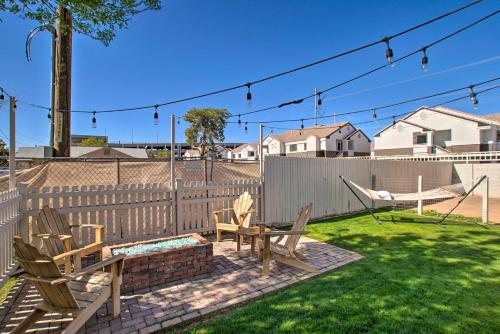 a backyard with chairs and a hammock and a fence at Walk to Downtown Gilbert Home with Fire Pit! in Gilbert