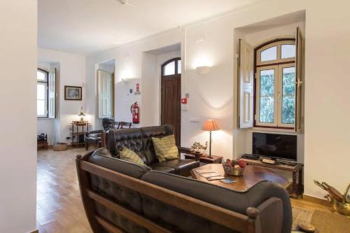 a living room with a couch and a table at Quinta do Americano in Sardoal