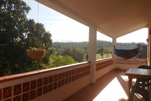 a hammock on the porch of a house at Quinta do Americano in Sardoal