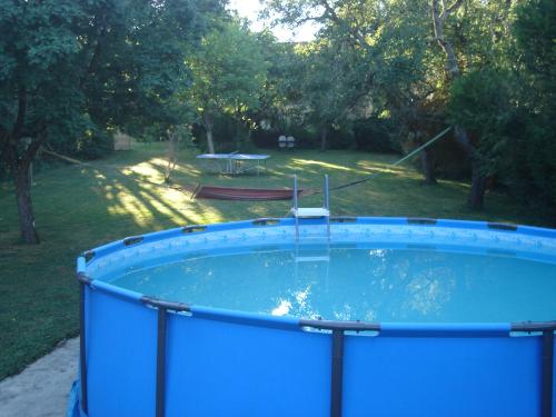 une grande baignoire bleue dans une cour avec une table de pique-nique dans l'établissement Gîte op camping Le Bonhomme, à Néret