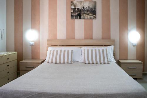 a bedroom with a large bed with two pillows at Appartamenti DeSi in Tropea