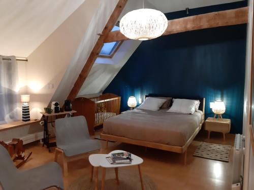 ein Schlafzimmer mit einem Bett und einer blauen Wand in der Unterkunft La Longère d'Arzoù, chambres d'hôtes in Baden