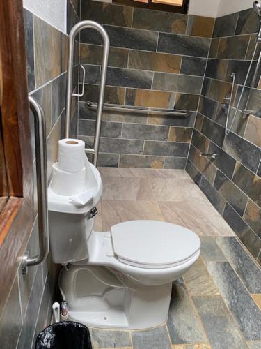 a bathroom with a white toilet in a shower at Finca Avellanas in Playa Avellana