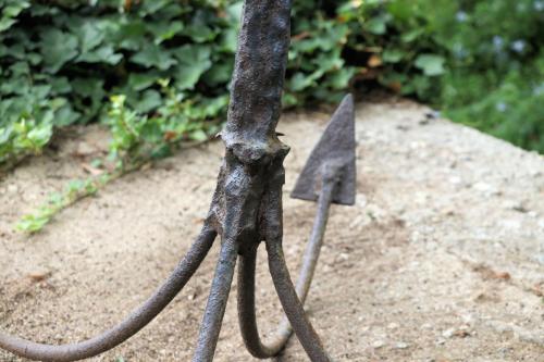 two metal swords are stuck in the ground at Case di Berto in Capo Vaticano