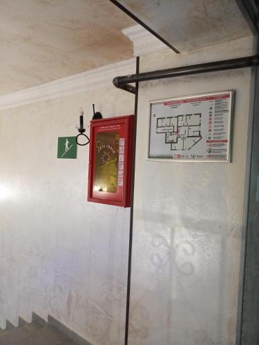 a wall with a red box and a map at Hotel Elite House in Mestia