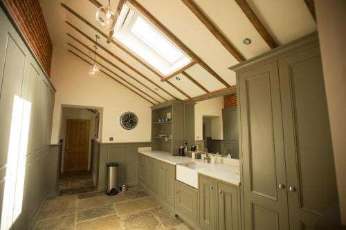 a large bathroom with a sink and a skylight at Channels Retreat in Chelmsford