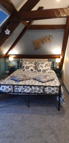 een slaapkamer met een bed op zolder bij LE CHALET SUISS - Chambre Santorin in Le Vicel
