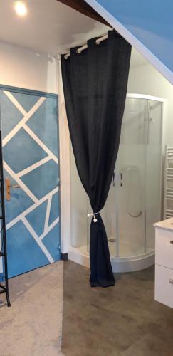 uma cortina preta num quarto com chuveiro em LE CHALET SUISS - Chambre Santorin em Le Vicel