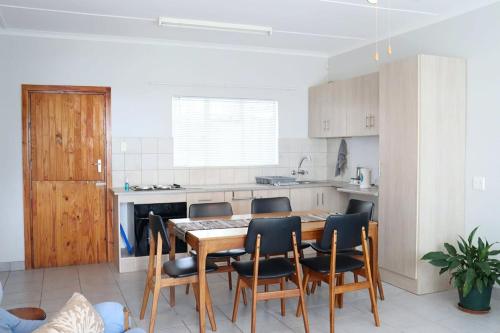 a dining room with a table and chairs in a kitchen at The Nook in Cradock