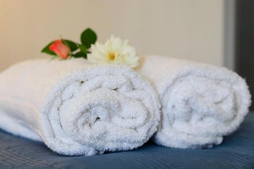a towel with a flower on top of a bed at The Nook in Cradock