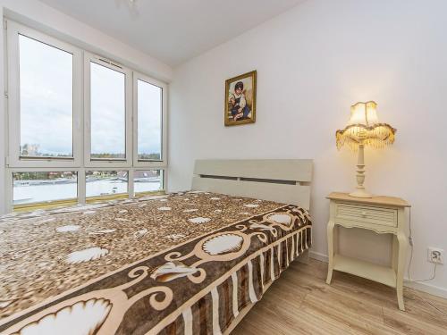 a bedroom with a large bed and a window at Nadmorski apartament w lesie in Jantar