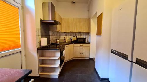 a small kitchen with a sink and a stove at Hostel Moderna Rest in Katowice