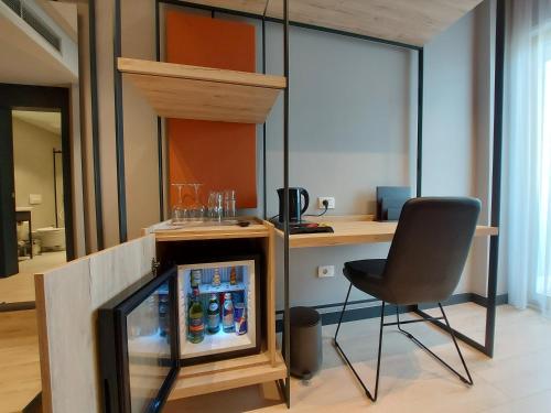 a chair and a television in a room at Mulaj Hotel in Tirana