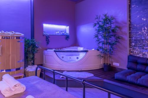 a purple bathroom with a tub and a sink at Green Town Apartments in Sombor