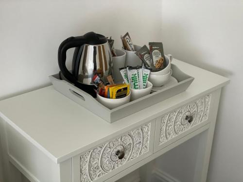 a white shelf with cups and a tea pot on it at The Nags Head - Room only accommodation in Lyme Regis