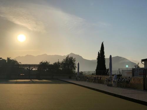 a view of the sun setting over the mountains at El Cid Country Club in Benidoleig