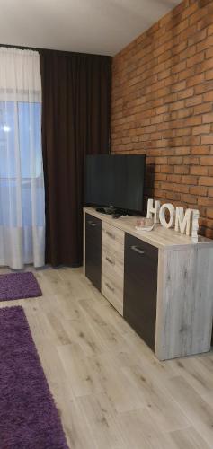 a living room with a flat screen tv on a table at Apartamenty Bartnicza C in Bielsko-Biała