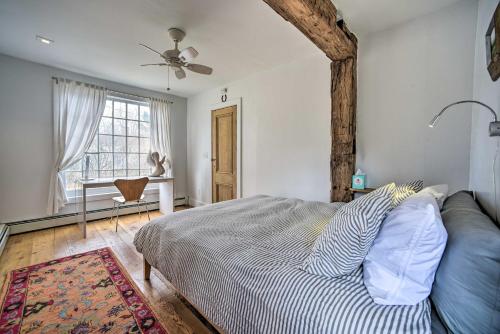 a bedroom with a bed and a couch and a window at Charming Cottage with Yard - 2 Mi to Tinker St! in Woodstock