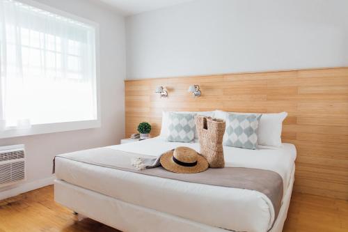 a bedroom with a bed with a hat on it at Riviere South Beach Hotel in Miami Beach