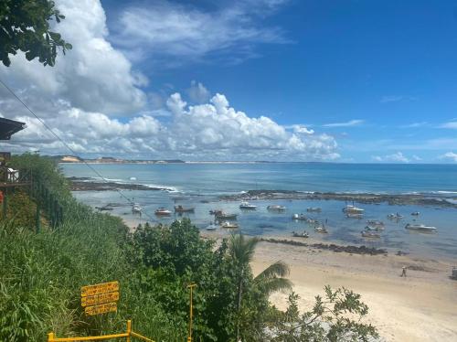 a view of a beach with boats in the water at Chalé 17 - Porto do Sol - Pipa in Pipa