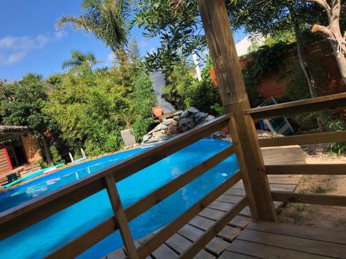 a view of a swimming pool through a fence at Posada Agua Marina in La Paloma