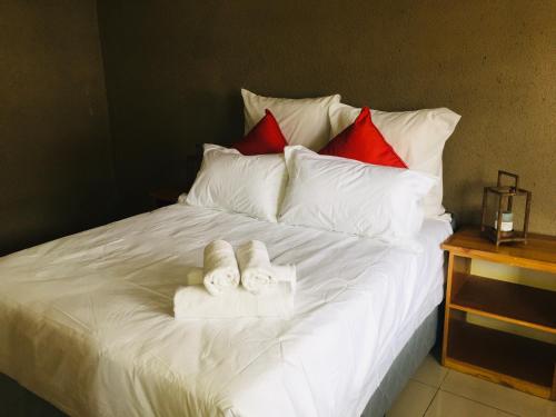 a bed with towels and pillows on it at Asante’s Guest House in Calcutta
