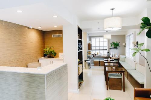 a living room and dining room with a kitchen and a dining table at Riviere South Beach Hotel in Miami Beach