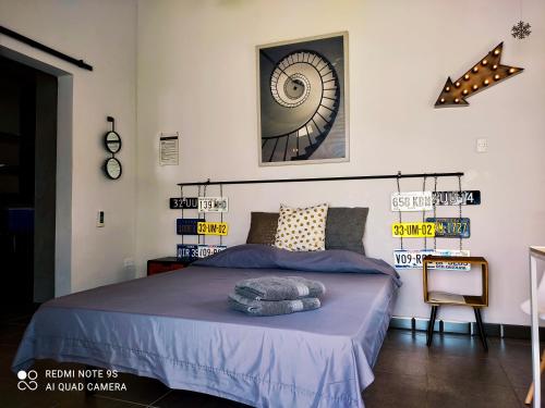 a bedroom with a bed with purple sheets and a mirror at Studios 11and11Aruba in Palm-Eagle Beach