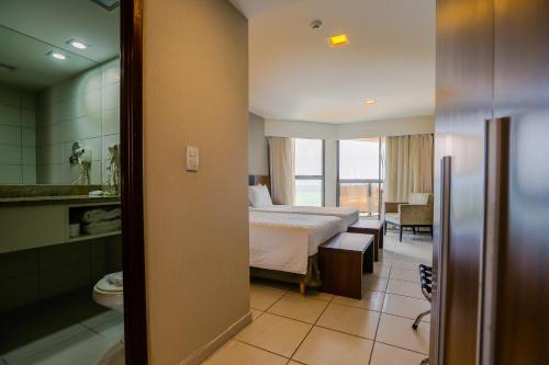 Ένα ή περισσότερα κρεβάτια σε δωμάτιο στο Transamerica Prestige Recife - Boa Viagem