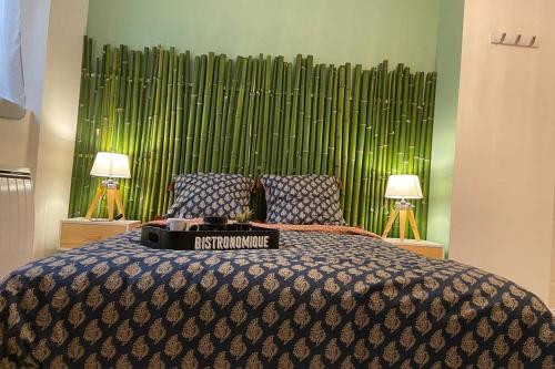 a bedroom with a large bed with two lamps at Une pause aux Halles. Maison de ville pour 5 pers max in Pontgouin