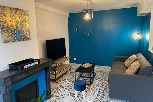 a living room with a couch and a fireplace at Une pause aux Halles. Maison de ville pour 5 pers max in Pontgouin