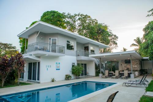 a house with a swimming pool in front of it at Uvita Paradise in Uvita