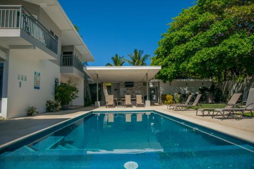 a swimming pool in front of a house at Uvita Paradise in Uvita