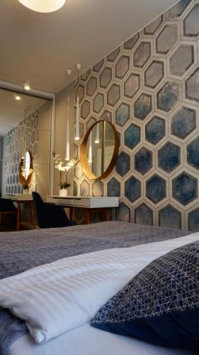 a bedroom with a large mirror and a bed at Apartament w samym sercu Opola-Faktura Vat - Self check-in in Opole