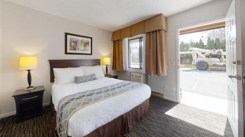 una camera d'albergo con un letto e una grande finestra di Recreation Inn and Suites a Kelowna