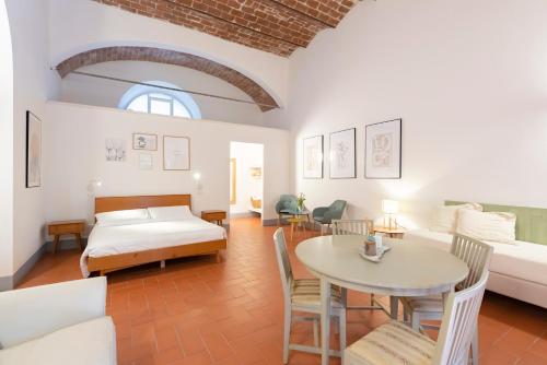 a living room with a bed and a table at Fattoria Pian Di Rocca in Castiglione della Pescaia