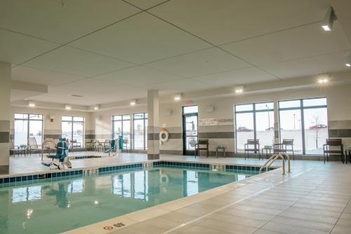 a swimming pool in a building with people in it at Courtyard by Marriott Fargo in Fargo