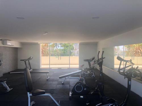 a gym with several treadmills and elliptical machines at Departamento de lujo en el Malecón in Mazatlán